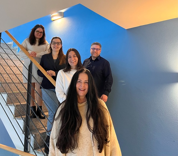 Das fünfköpfige Human Ressources-Team posiert für ein Gruppenbild im Treppenhaus.